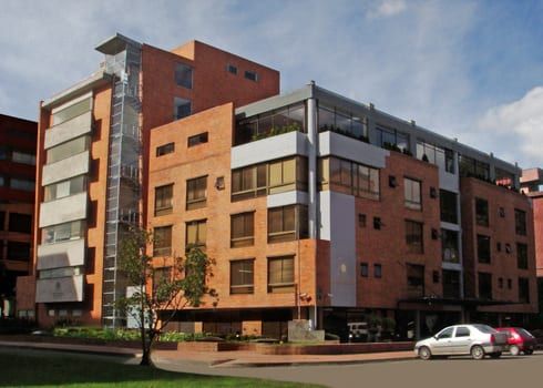 Médico especialista revisando resultados de ecografía con paciente embarazada en consulta ginecológica de clínica en Bogotá