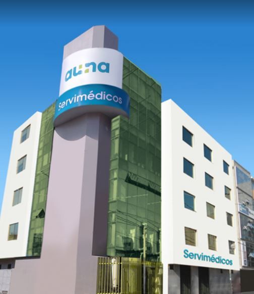 Médico especialista atendiendo a un paciente en consulta externa del Centro Médico Servimédicos en Chiclayo, con equipos de diagnóstico visibles al fondo